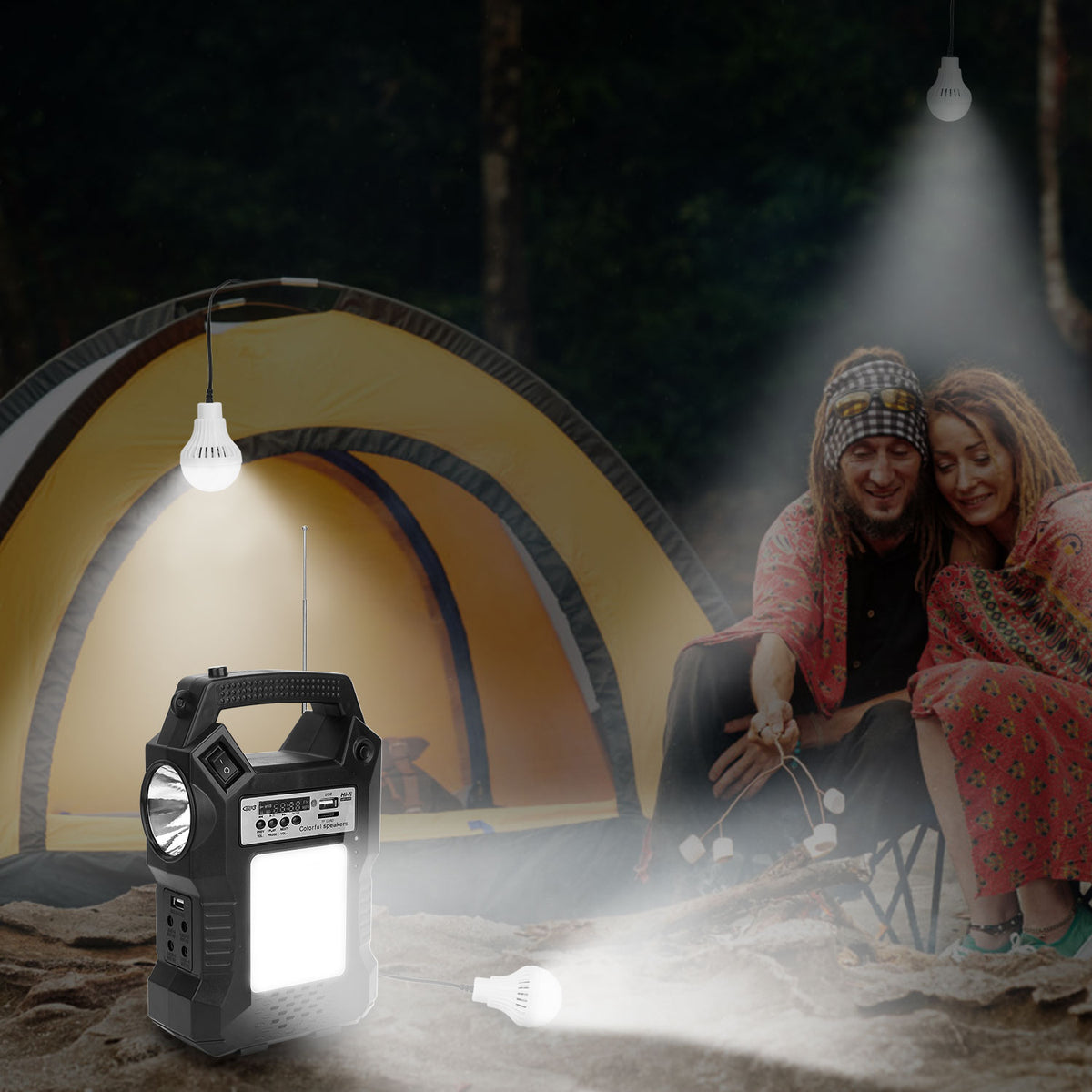 A portable camping lantern and light source shown in a nighttime camp scene beside a tent, with a couple sitting nearby and hanging bulb lights illuminating the scene.
