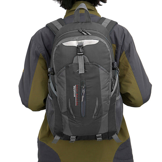 Person wearing a gray backpack with a visible brand logo on a white background