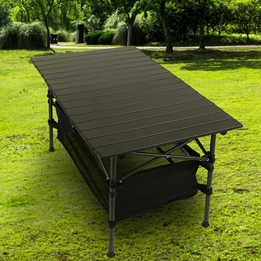 Portable folding table on grass with trees in the background