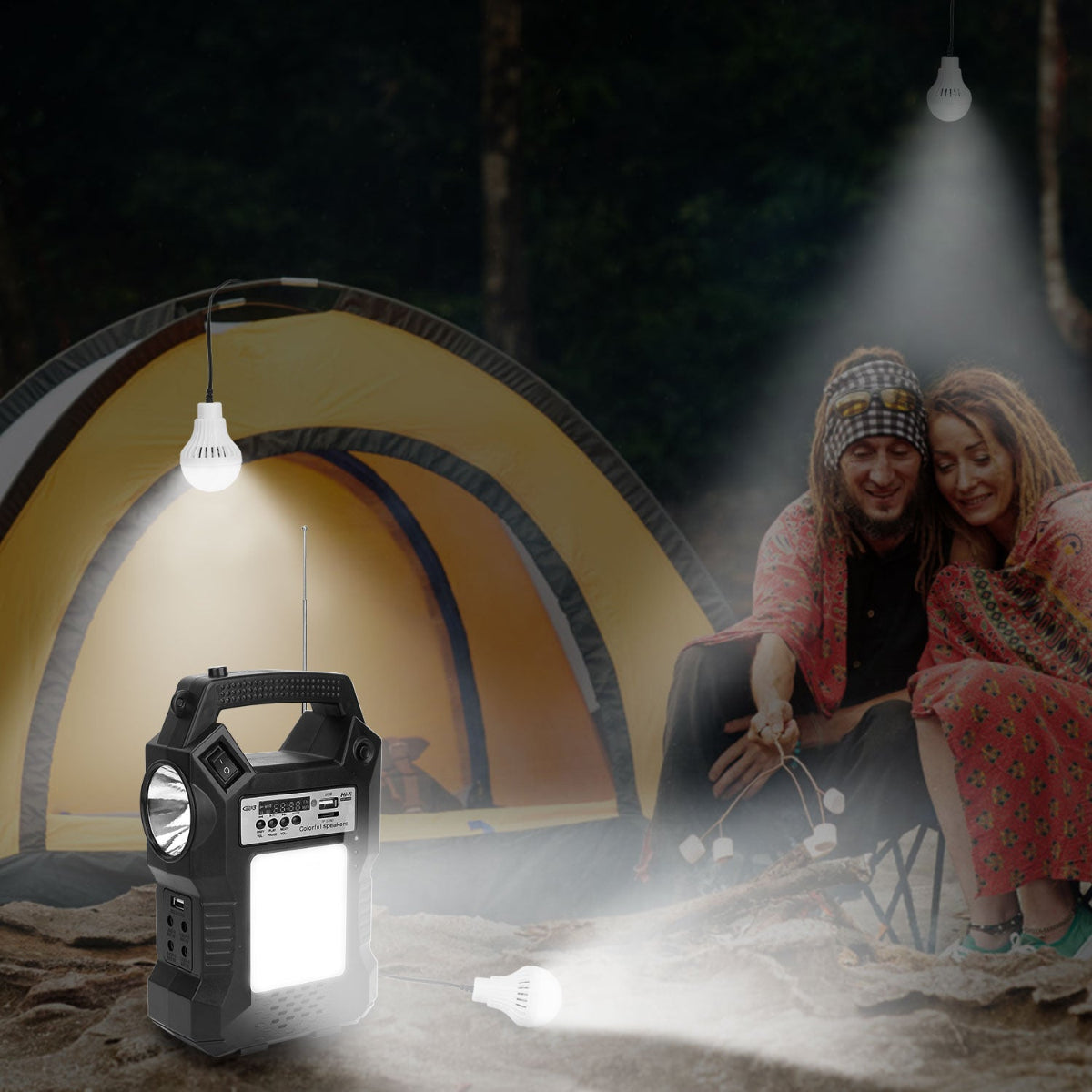 Portable solar power station lighting a tent at an outdoor campsite at night