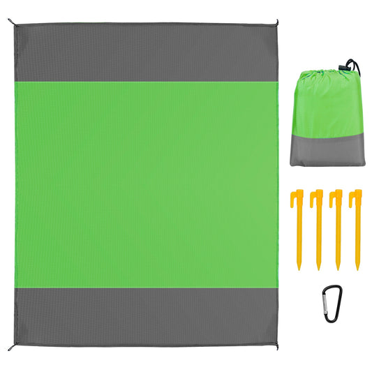 Green and gray outdoor mat with carrying bag and stakes on a white background