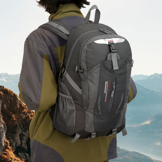 Backpack worn outdoors on a hiker overlooking a mountain landscape