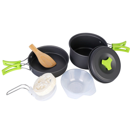 Set of black camping cookware with green handles on a white background