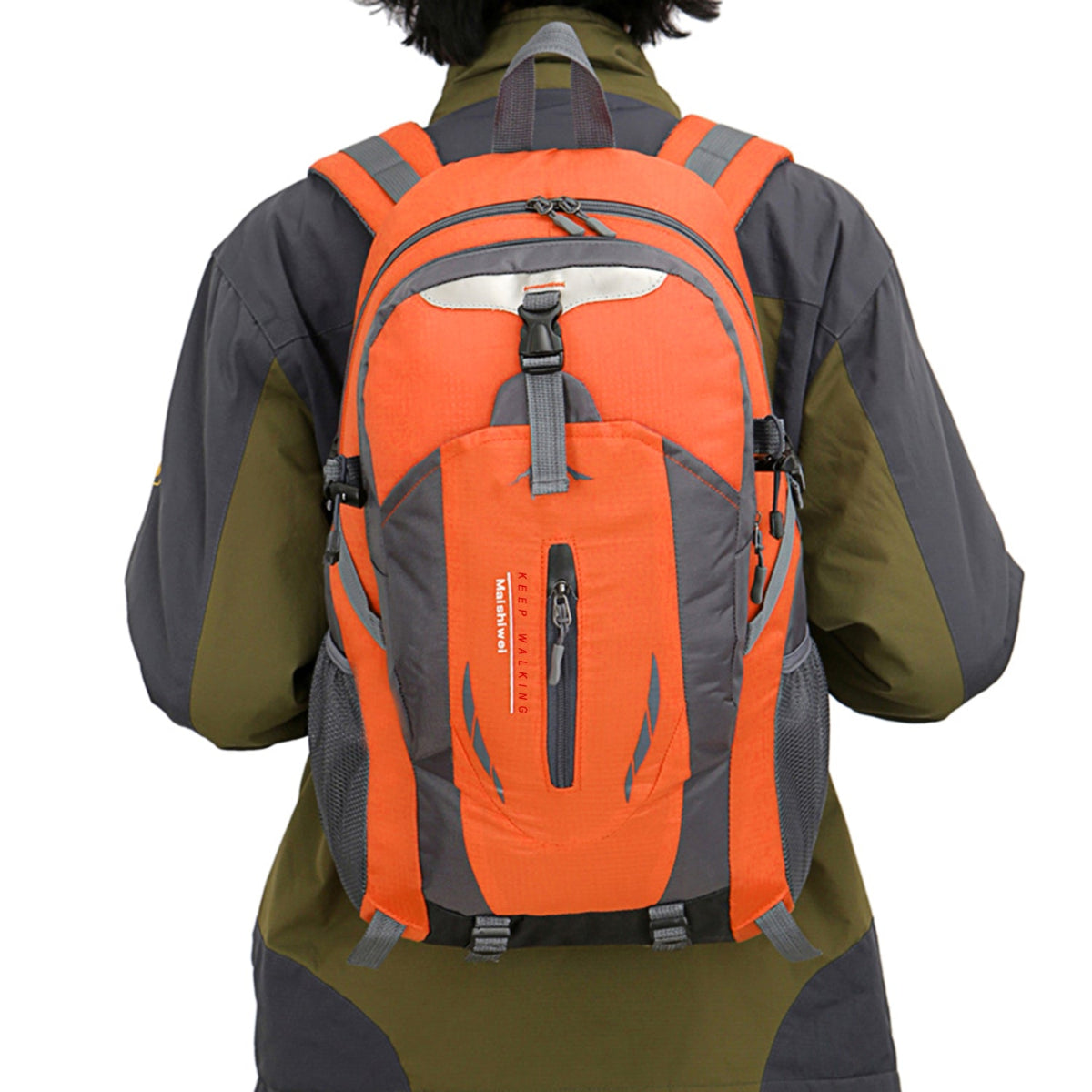 Person wearing an orange and gray backpack on a white background