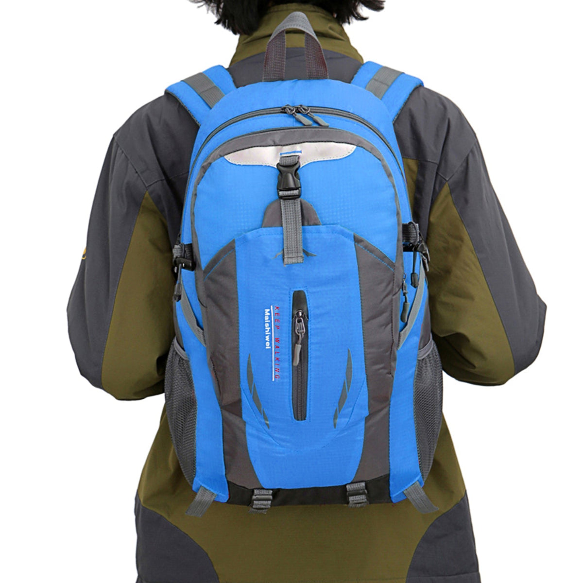 Person wearing a blue and gray backpack on a white background