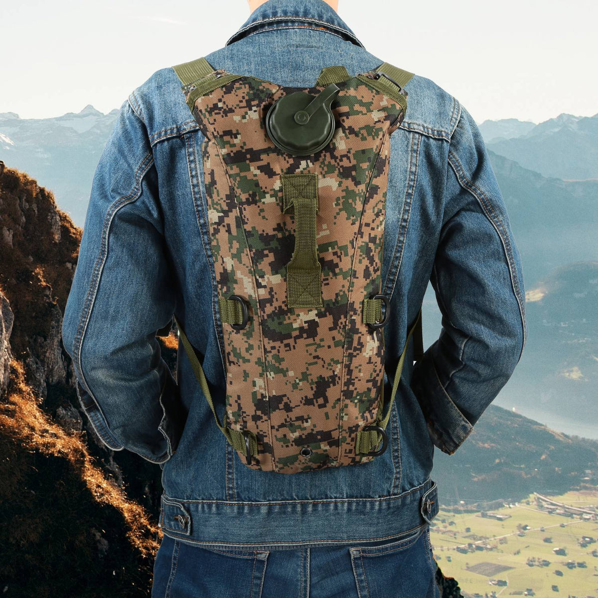 Person wearing a camouflage hydration pack with a mountainous landscape in the background