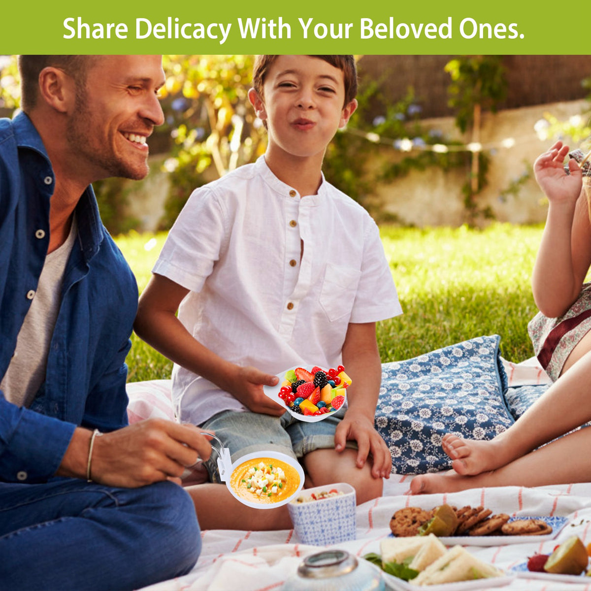 Family enjoying a picnic in a park with food and drinks.