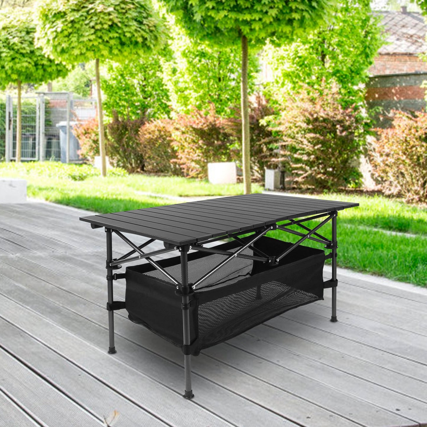 Black folding table with storage compartments on a wooden deck