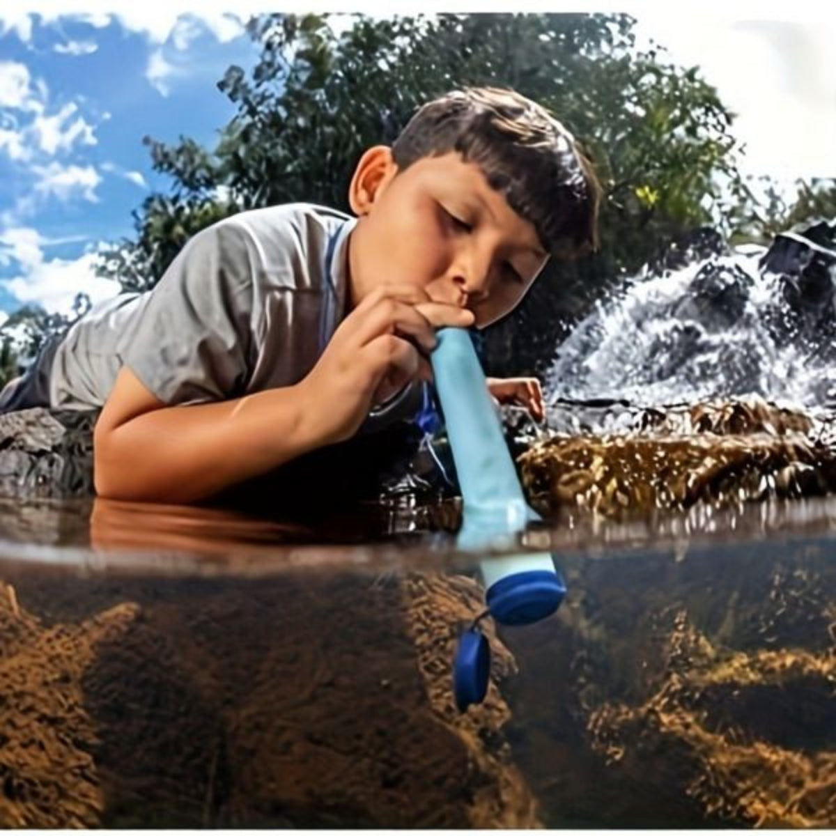 Child drinking water from a blue filter in a natural setting