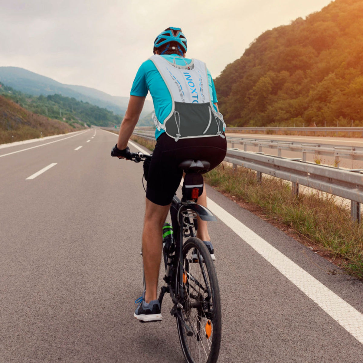 Cyclist on a road with a scenic background