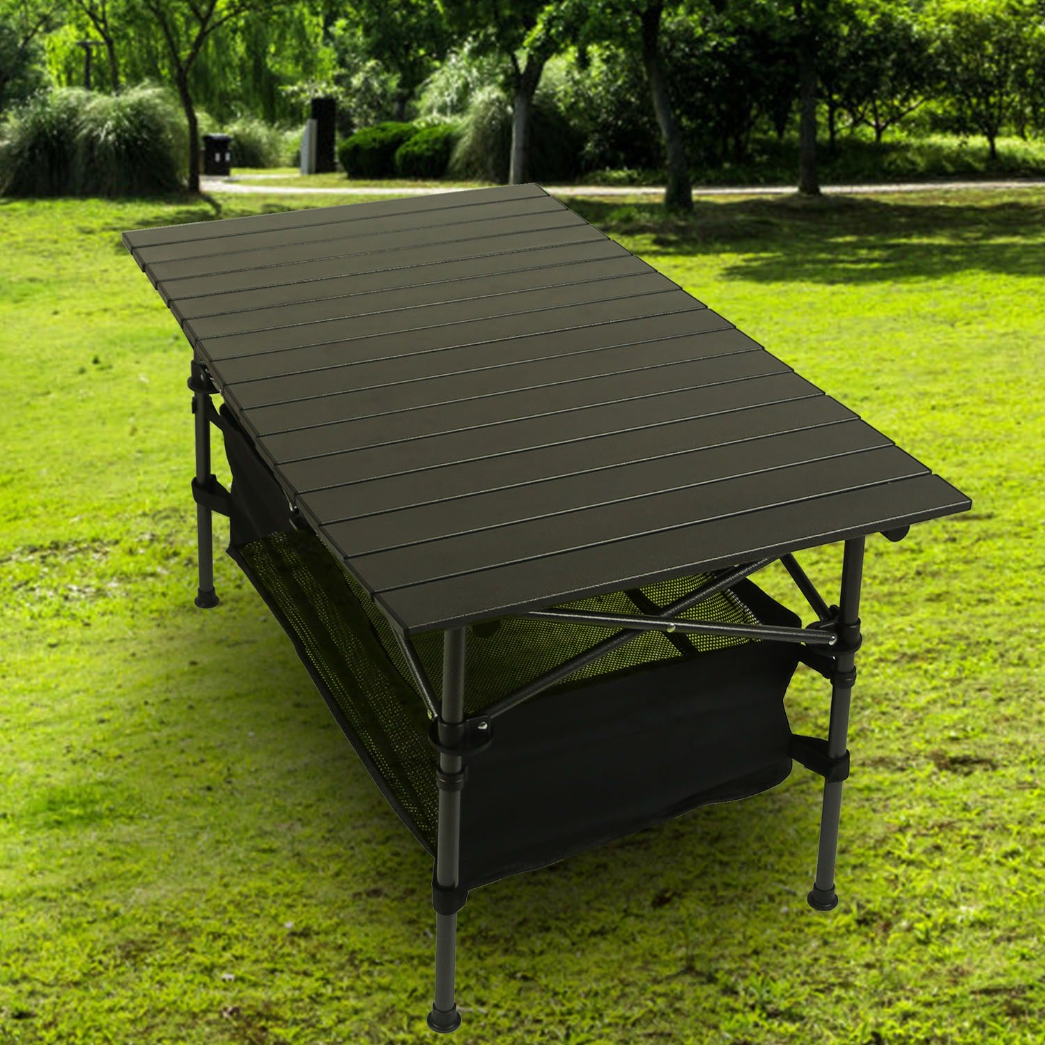 Portable folding table on grass with trees in the background