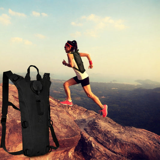 Hiker wearing tactical hydration pack on outdoor trail