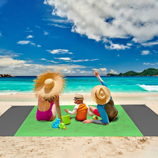 Foldable camping mat used for seating on sandy beach