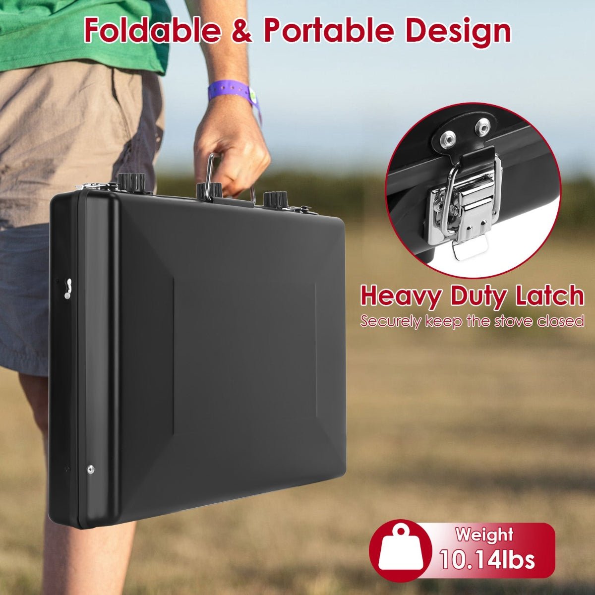 Folded black camping stove carried by hand outdoors, showing compact suitcase-style design