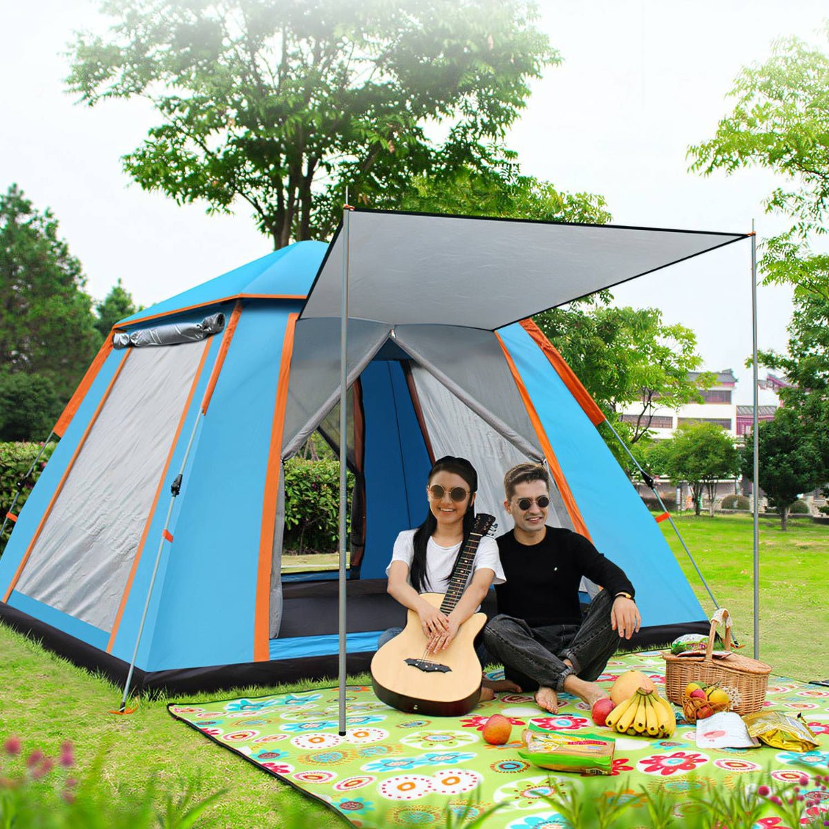 Camping tent entrance open with people seated on a ground mat in front