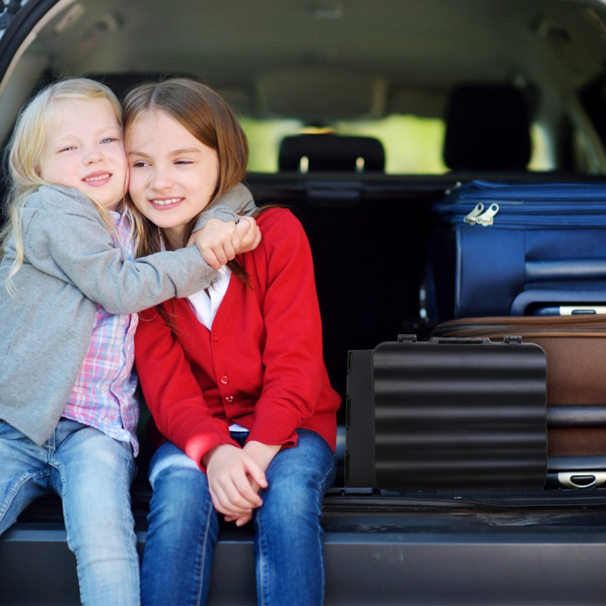 Folded portable toilet stored in vehicle trunk beside luggage